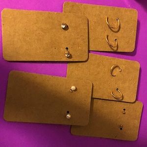 This is a five pack of earrings two gold pairs of hoops one gold pair of ball es